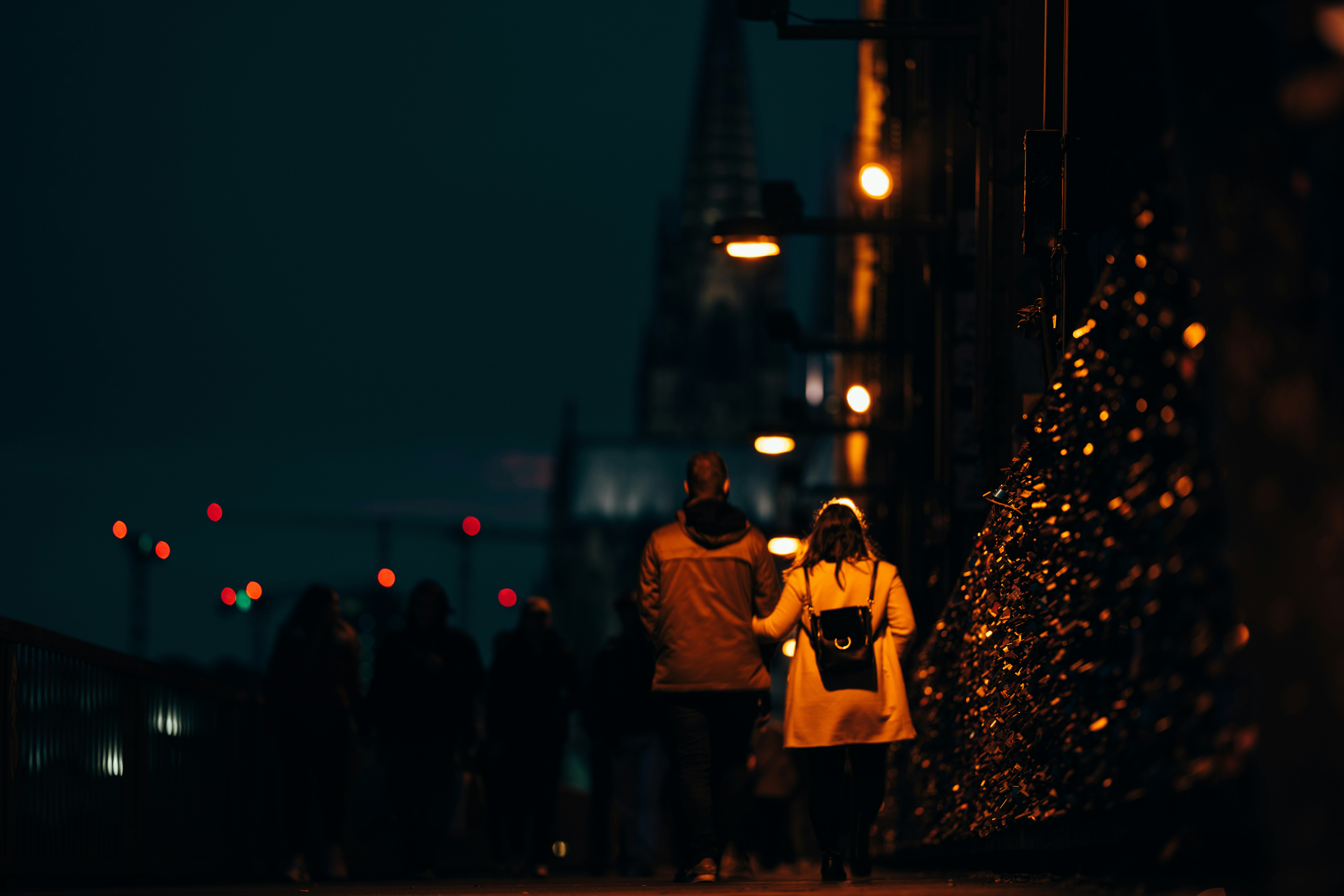 man in yellow jacket standing beside woman in yellow coat during night time